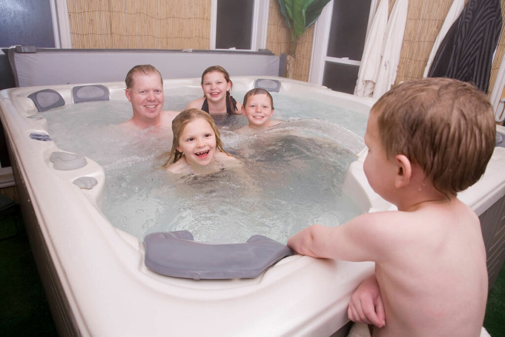 A father and kids in hot tub