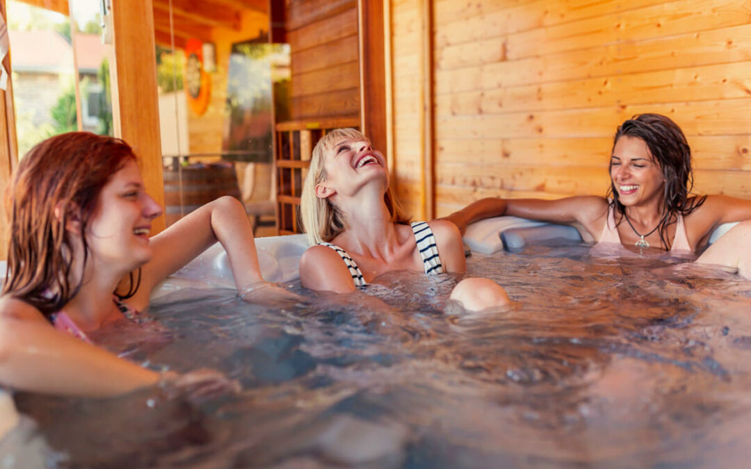 Girl friends relaxing in a hot tub while on a vacation