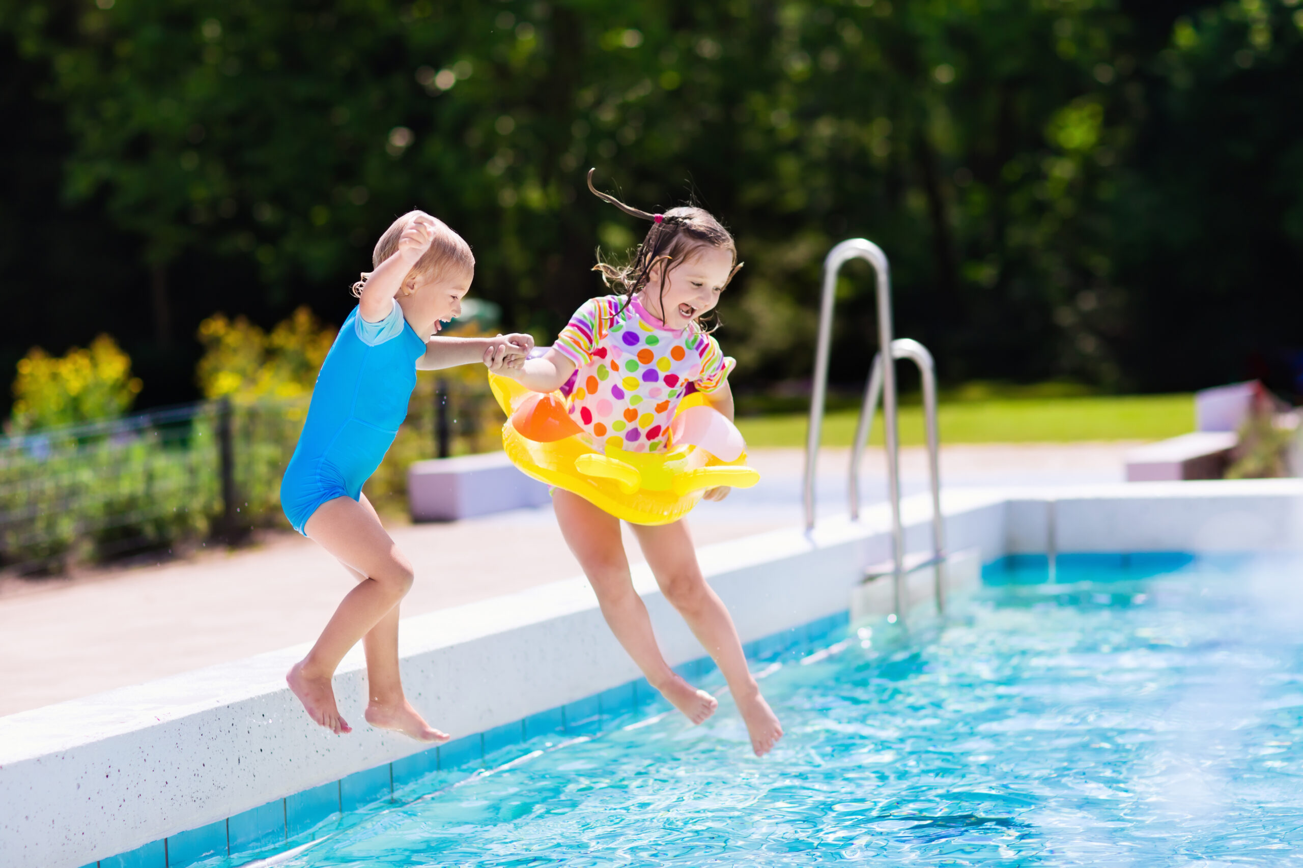 Kids jumping into swimming pool