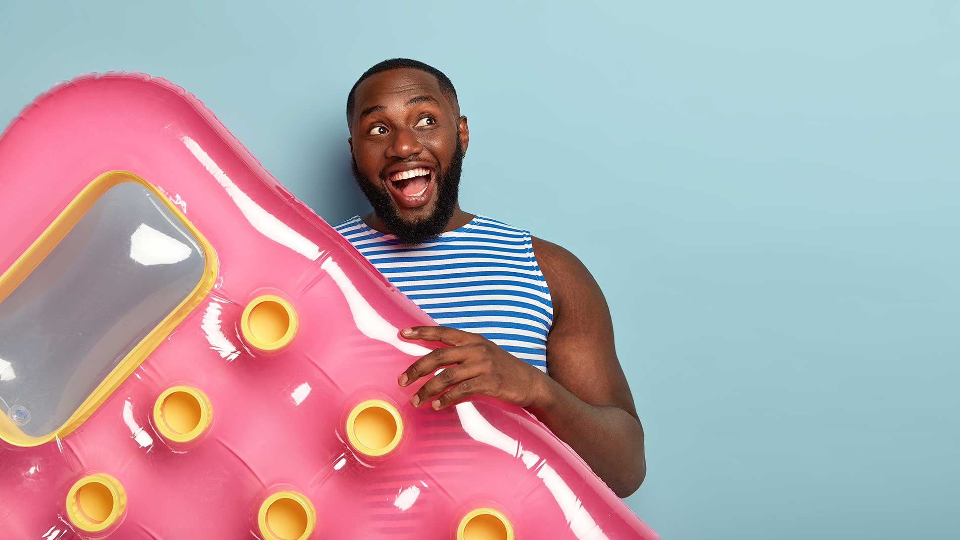 man-smiling-while-holding-a-pool-floatie man-smiling-while-holding-a-pool-floatie